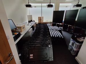 A room full of monitors stacked on the ground