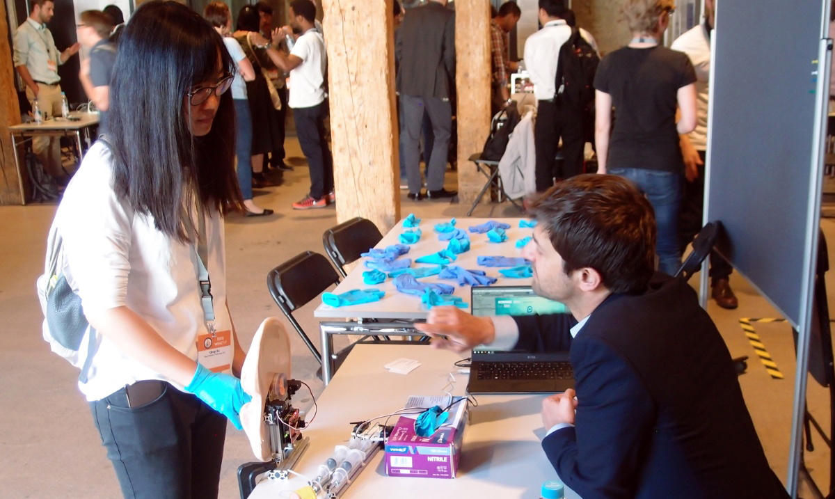 A conference delegate is talked through a demonstration of the device by Luc Maréchal