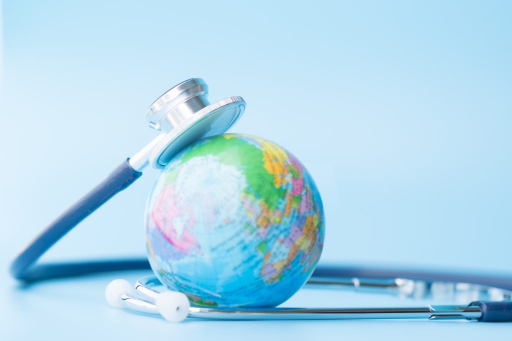A globe surrounded by a stethoscope.