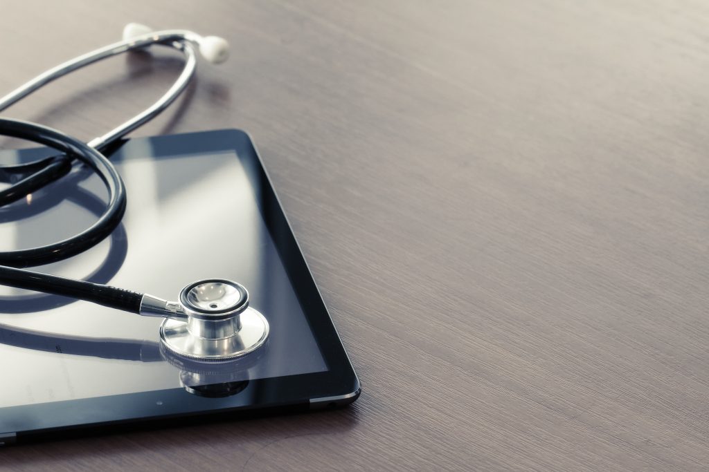 An ipad and stethoscope representing digital health technology