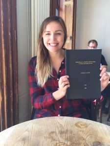Mental health researcher Lindsay with a book
