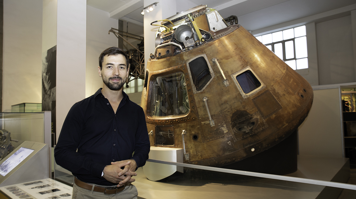 Dr Matthieu Komorowski in front of the Apollo 10 on display at the Science Museum. The spacecraft was used as the dress rehearsal for the actual Apollo 11 landing.